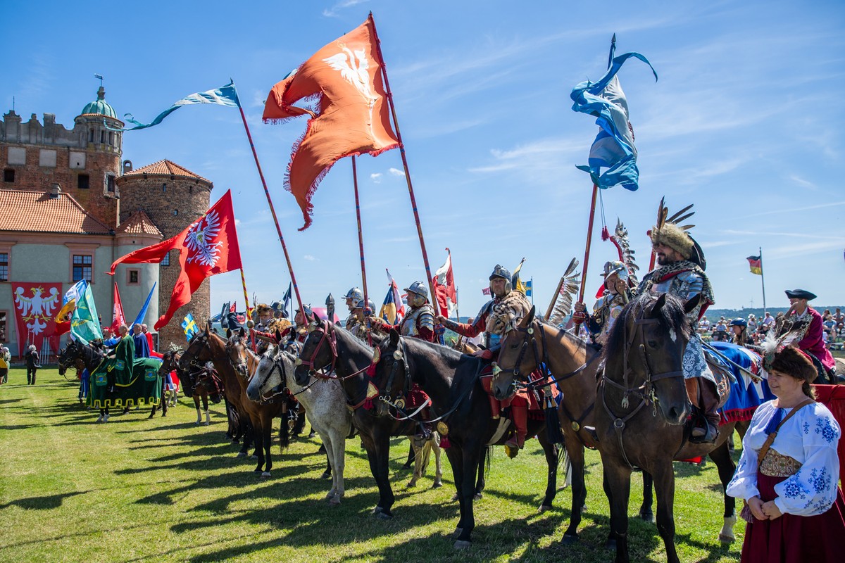 Knights in a row sitting on horses with banners